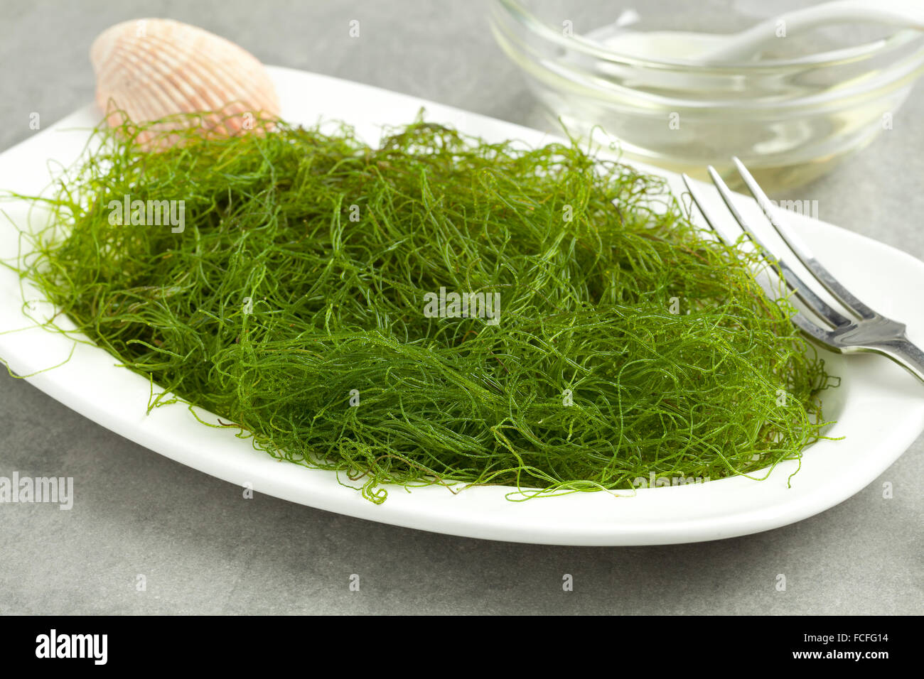 Dish with fresh filamentous green algaeas a side dish Stock Photo