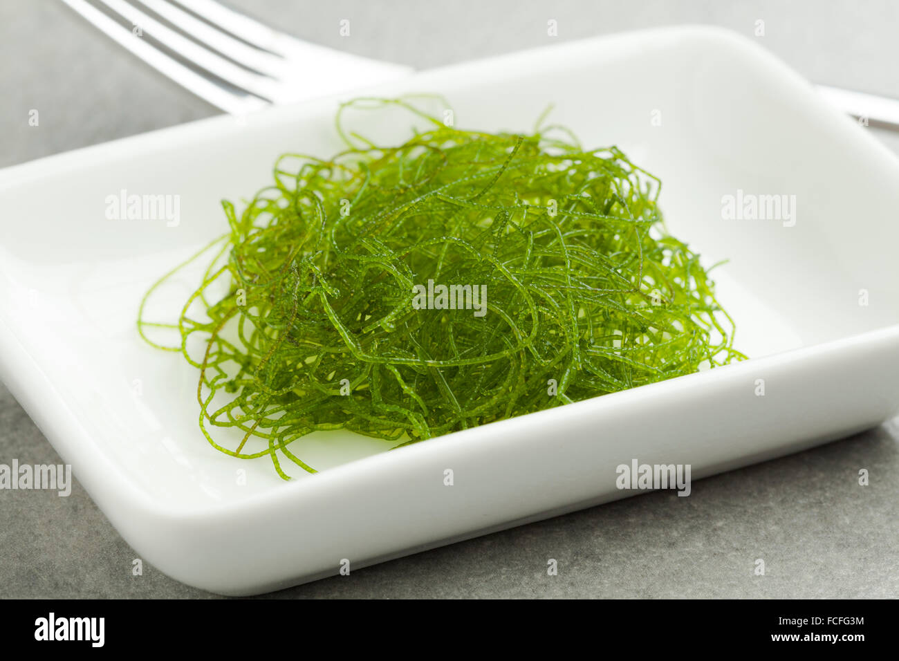 Dish with fresh filamentous green algae as a side dish Stock Photo