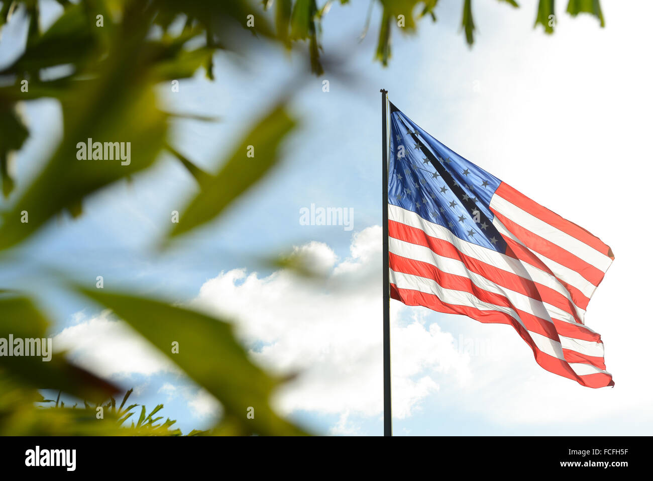 United States of America (USA) flag waving at the boardwalk in the town of Arroyo, Puerto Rico. Caribbean Island. USA territory. Stock Photo
