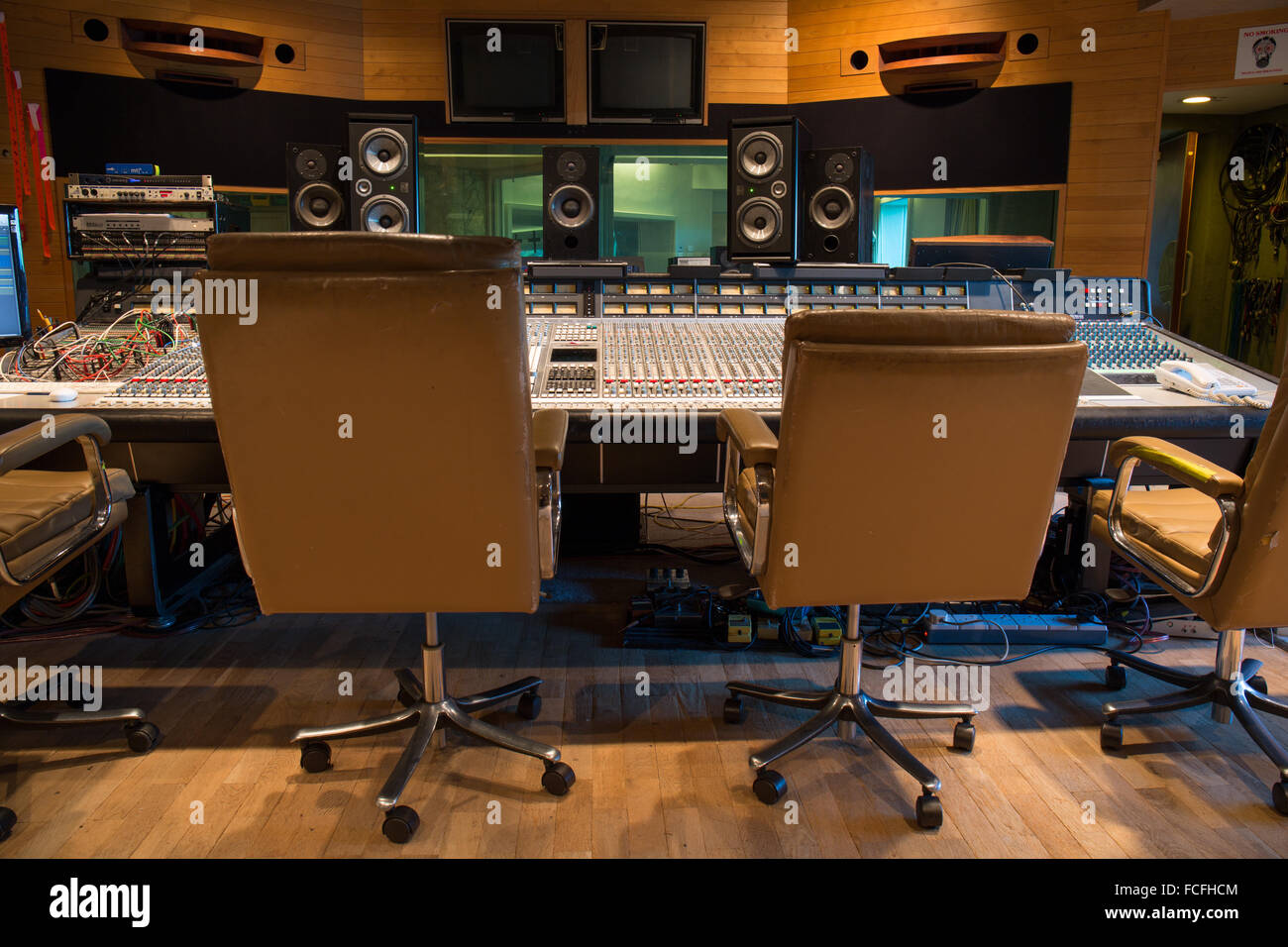 side view of ssl e series sound mixing desk with focal professional twin 6be and pro ac studio 100 and 1mk 2 studio speakers Stock Photo