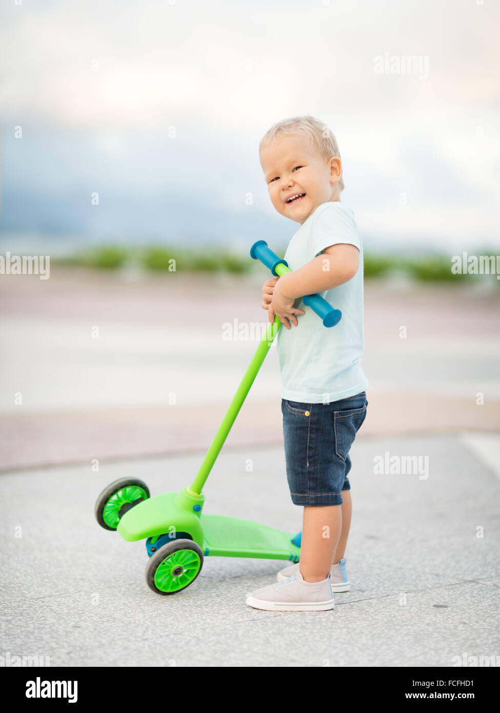 Boy with scooter outdoor. Leisure activity Stock Photo