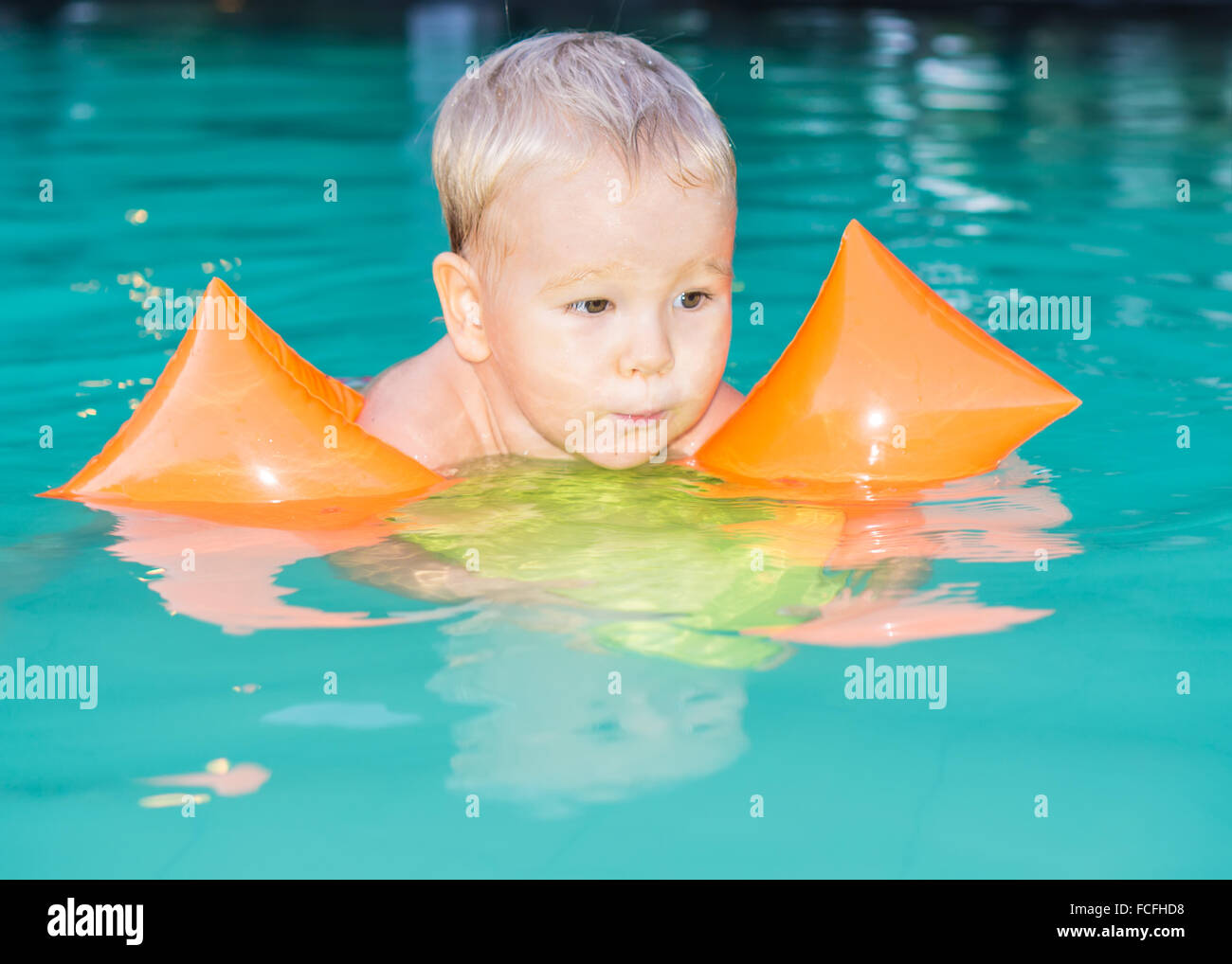 Baby with armbands in swimming pool Stock Photo Alamy
