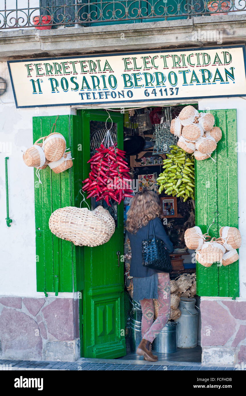 Woman entering on an old store In the Hondarribia oldtown. Basque Country. Spain. Stock Photo