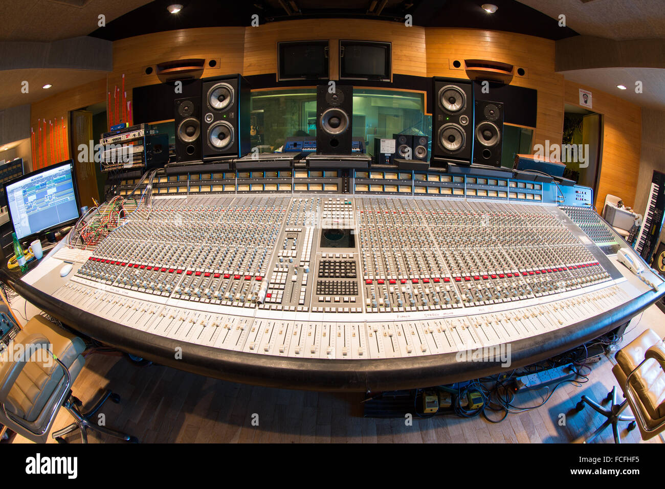 side view of ssl e series sound mixing desk with focal professional twin 6be and pro ac studio 100 and 1mk 2 studio speakers Stock Photo