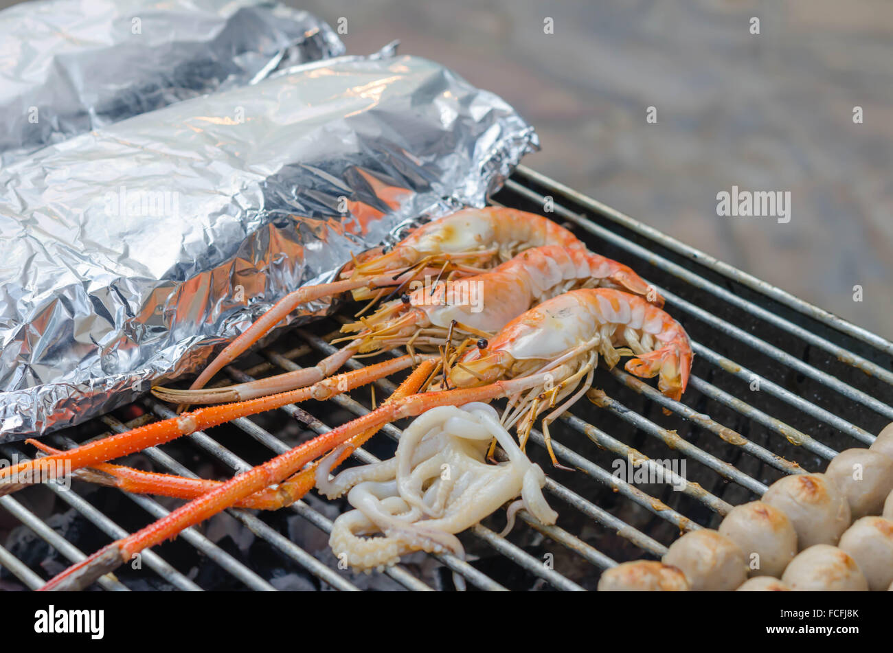 Grilled prawns , squid on flaming grill , seafood bbq Stock Photo