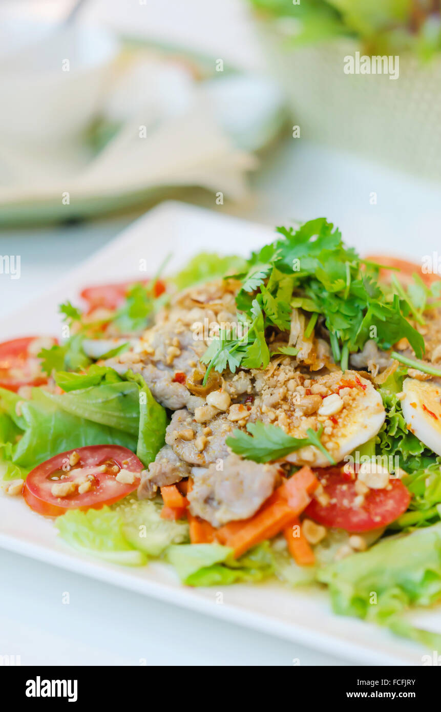 spicy salad with egg , pork and fresh vegetable Stock Photo