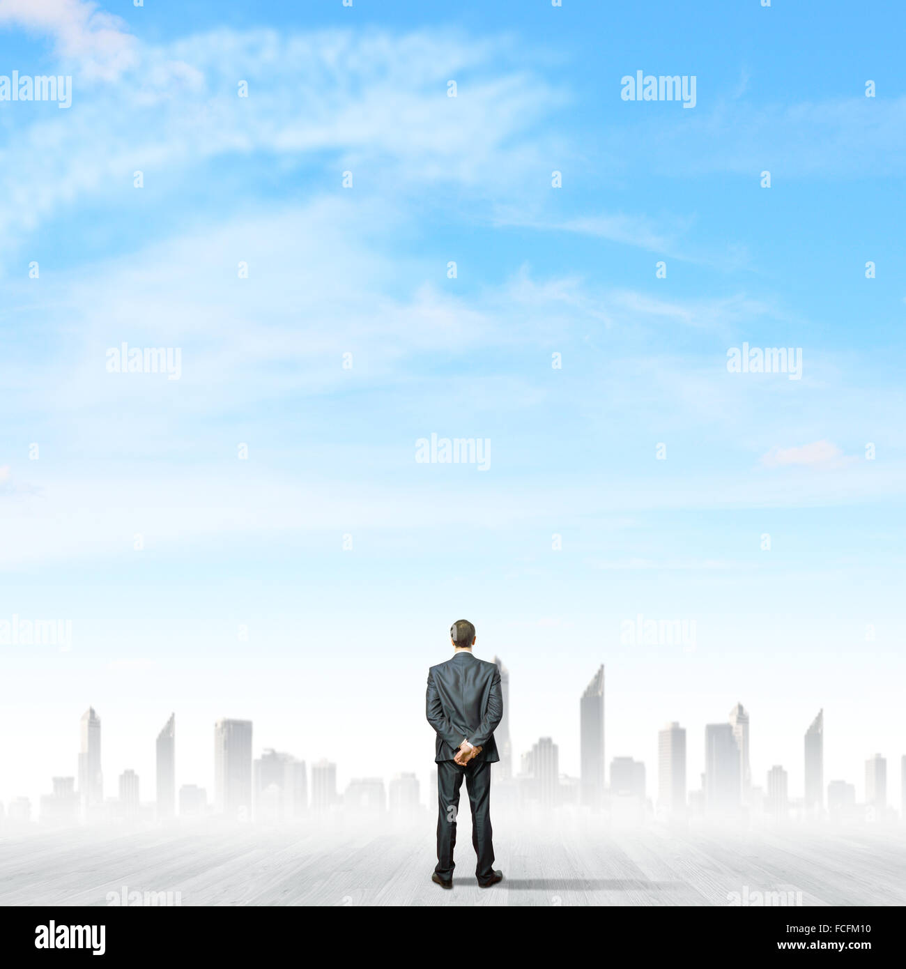 Rear view of businessman standing near ladder going high in sky Stock ...