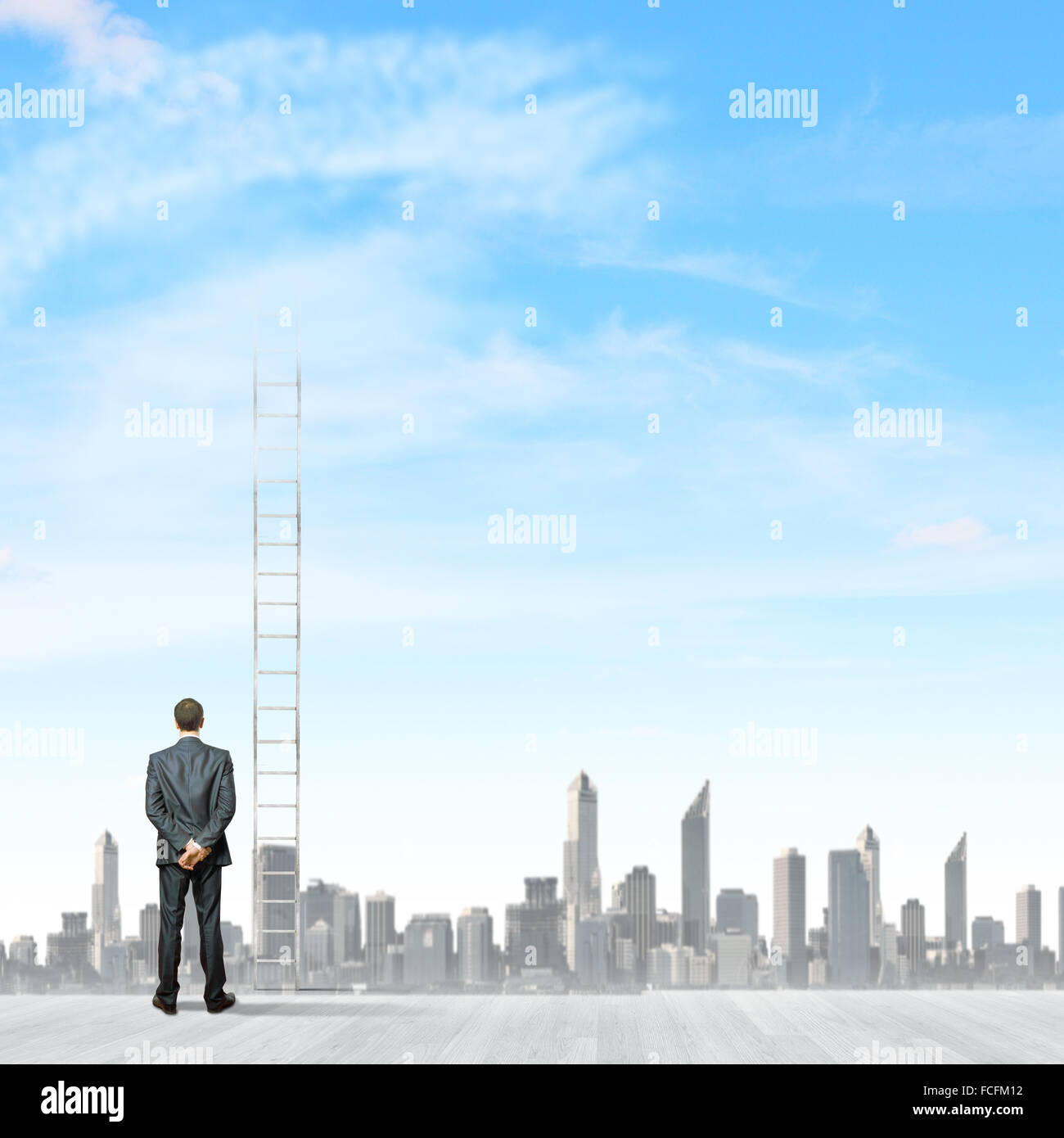 Rear view of businessman standing near ladder going high in sky Stock ...