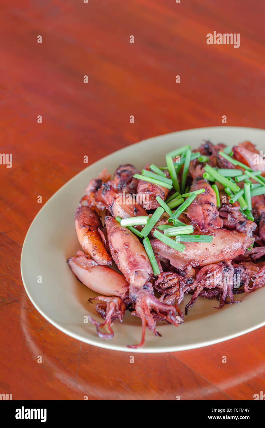 plate of sauteed small squid fried with garlic and sauce Stock Photo