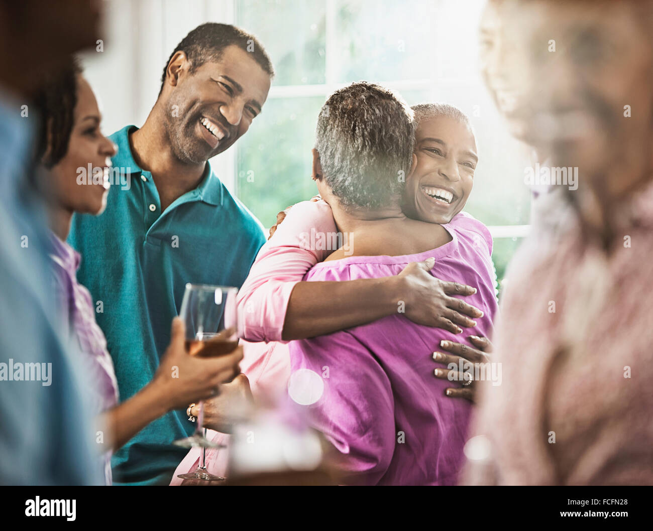 A group of African Americans of similar age, the baby boomer generation, having a party. Men and women. Stock Photo