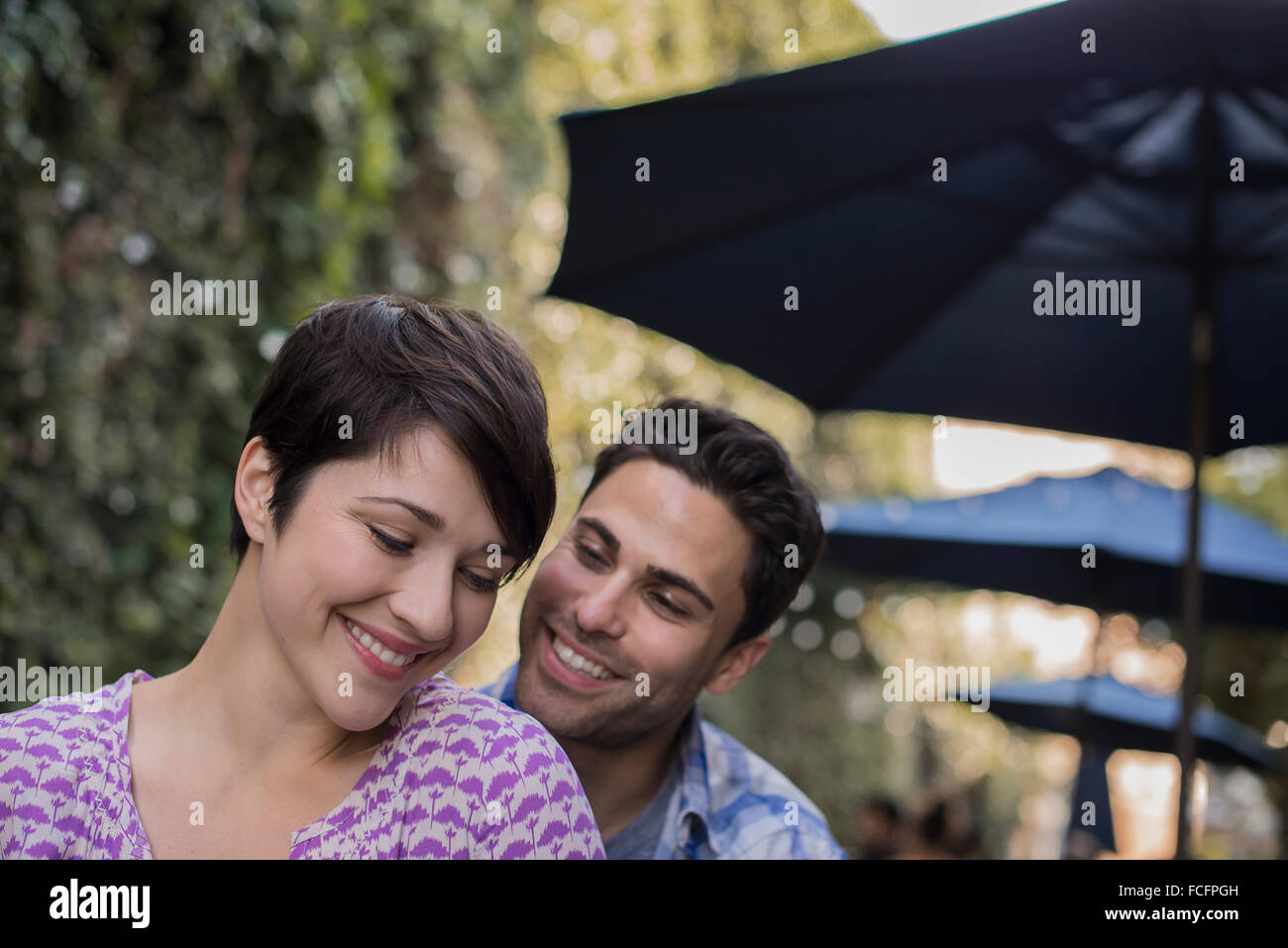 A couple, man and woman sitting at an outdoor cafe Stock Photo - Alamy