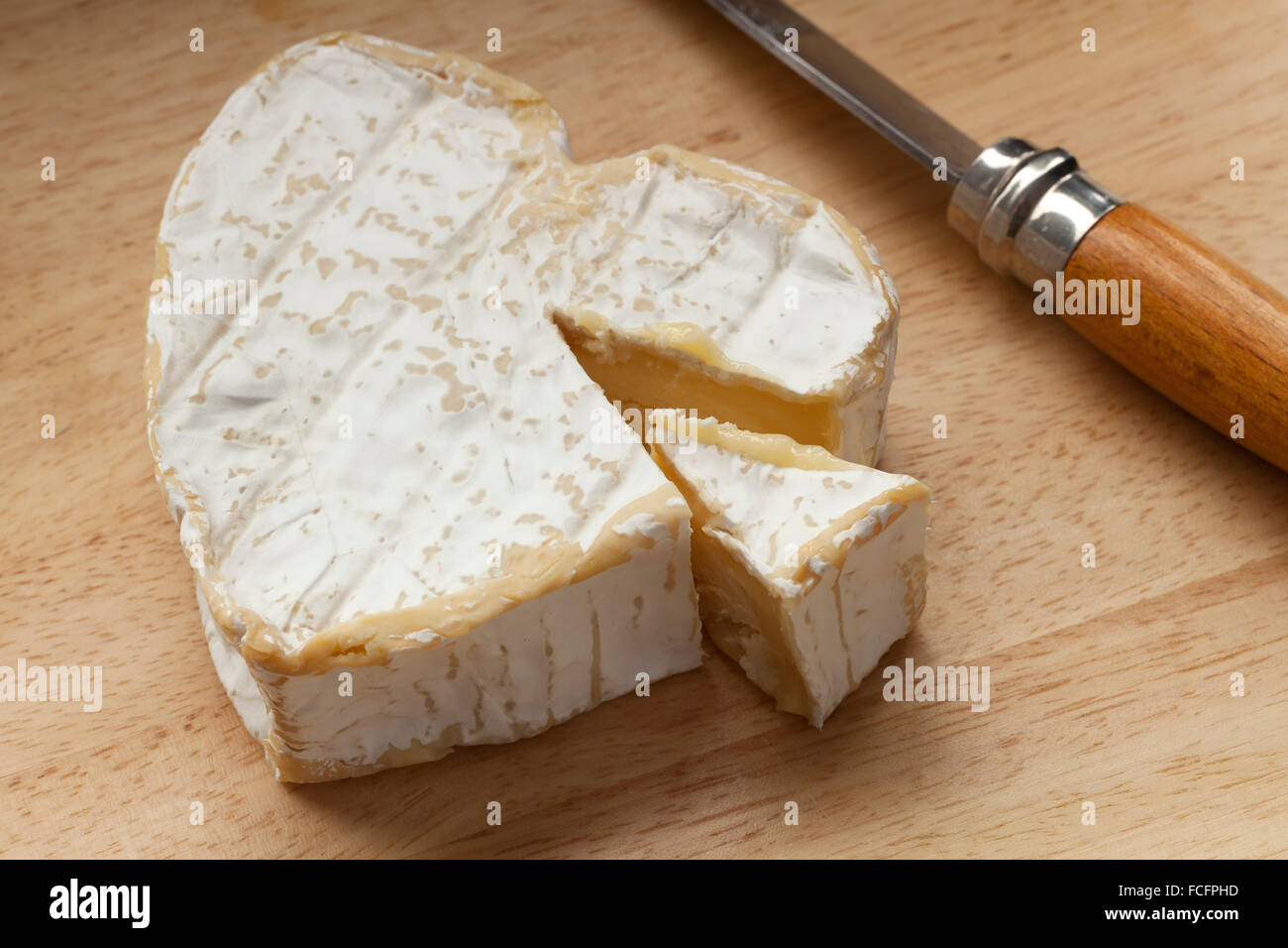 Traditional French neuchatel ripe cheese and a slice Stock Photo