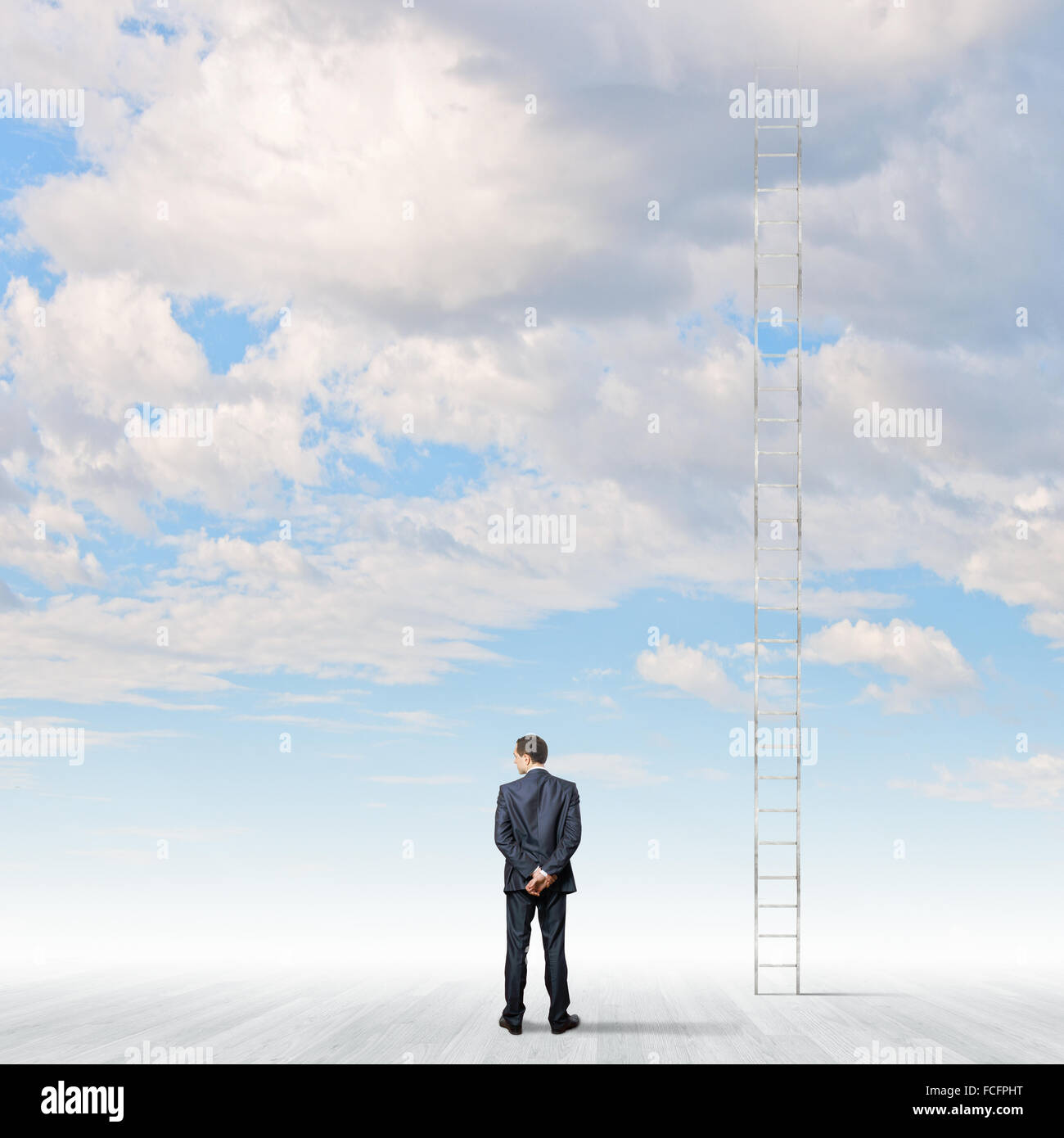Rear view of businessman standing near ladder going high in sky Stock ...