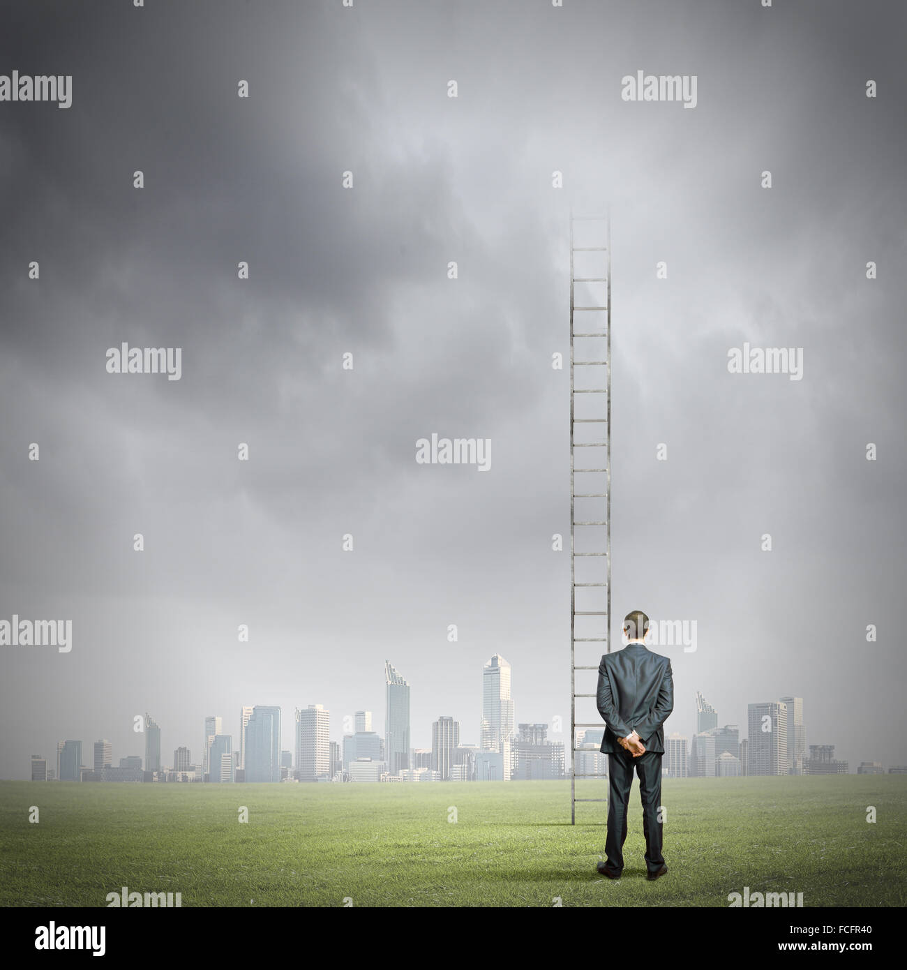 Rear view of businessman standing near ladder going high in sky Stock ...