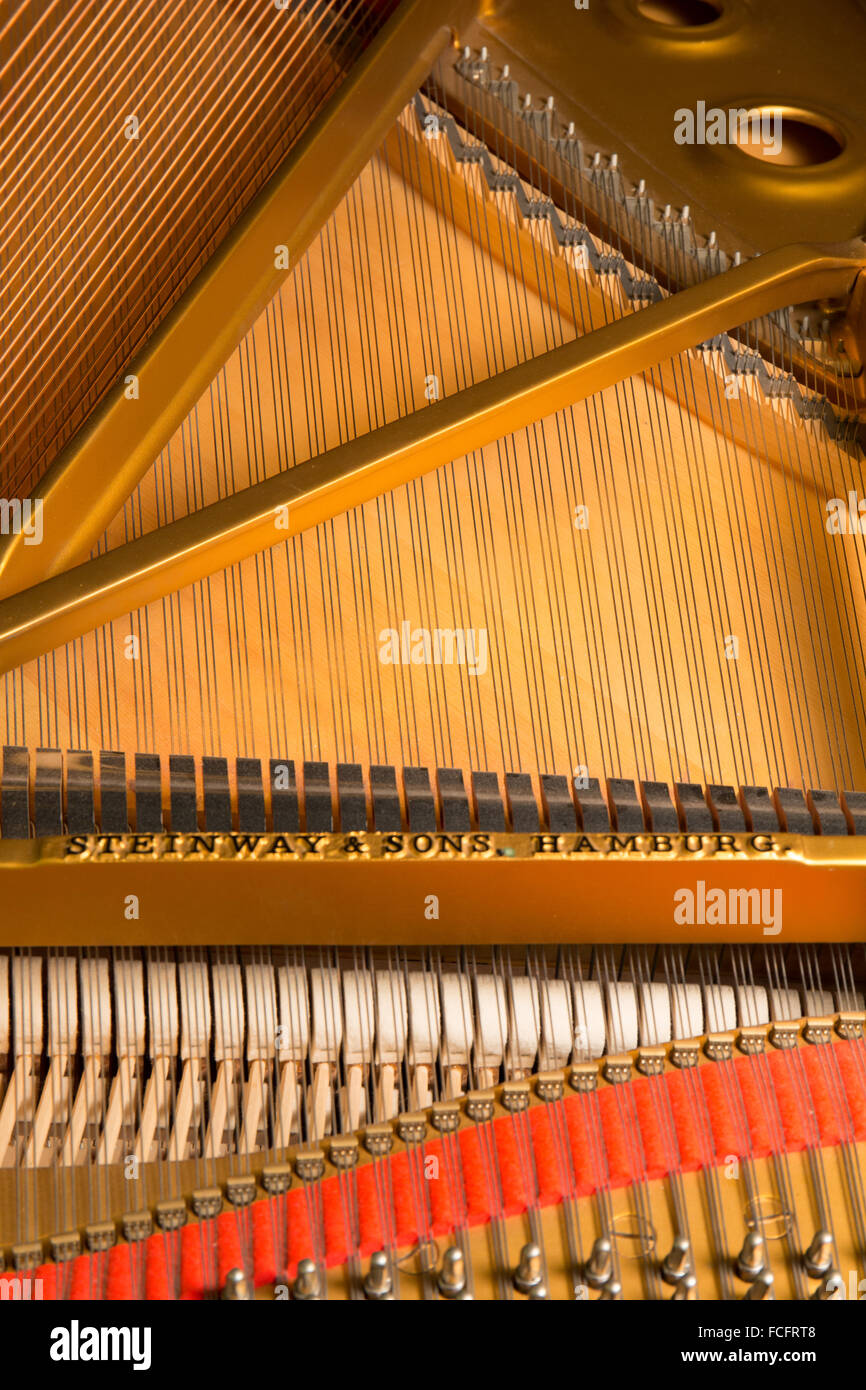 close up shot of a black steinway & sons model b grand piano with the lid open showing the strings inside Stock Photo