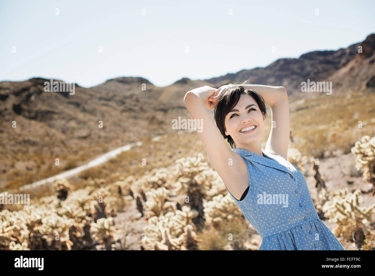 A young woman in a desert landscape. Stock Photo