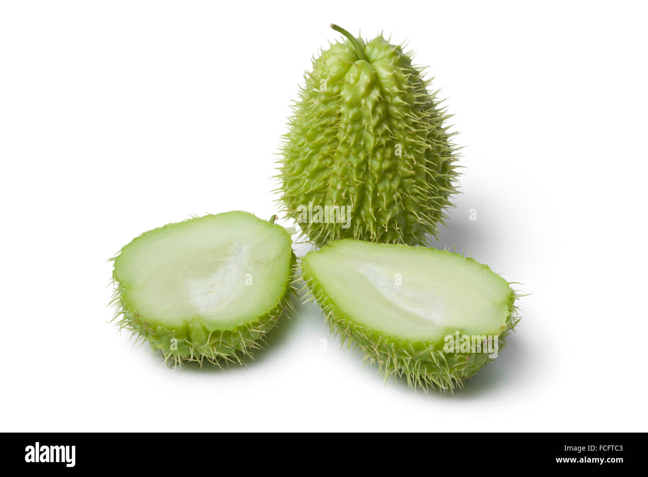 Whole and half spined fresh chayote fruit on white background Stock Photo