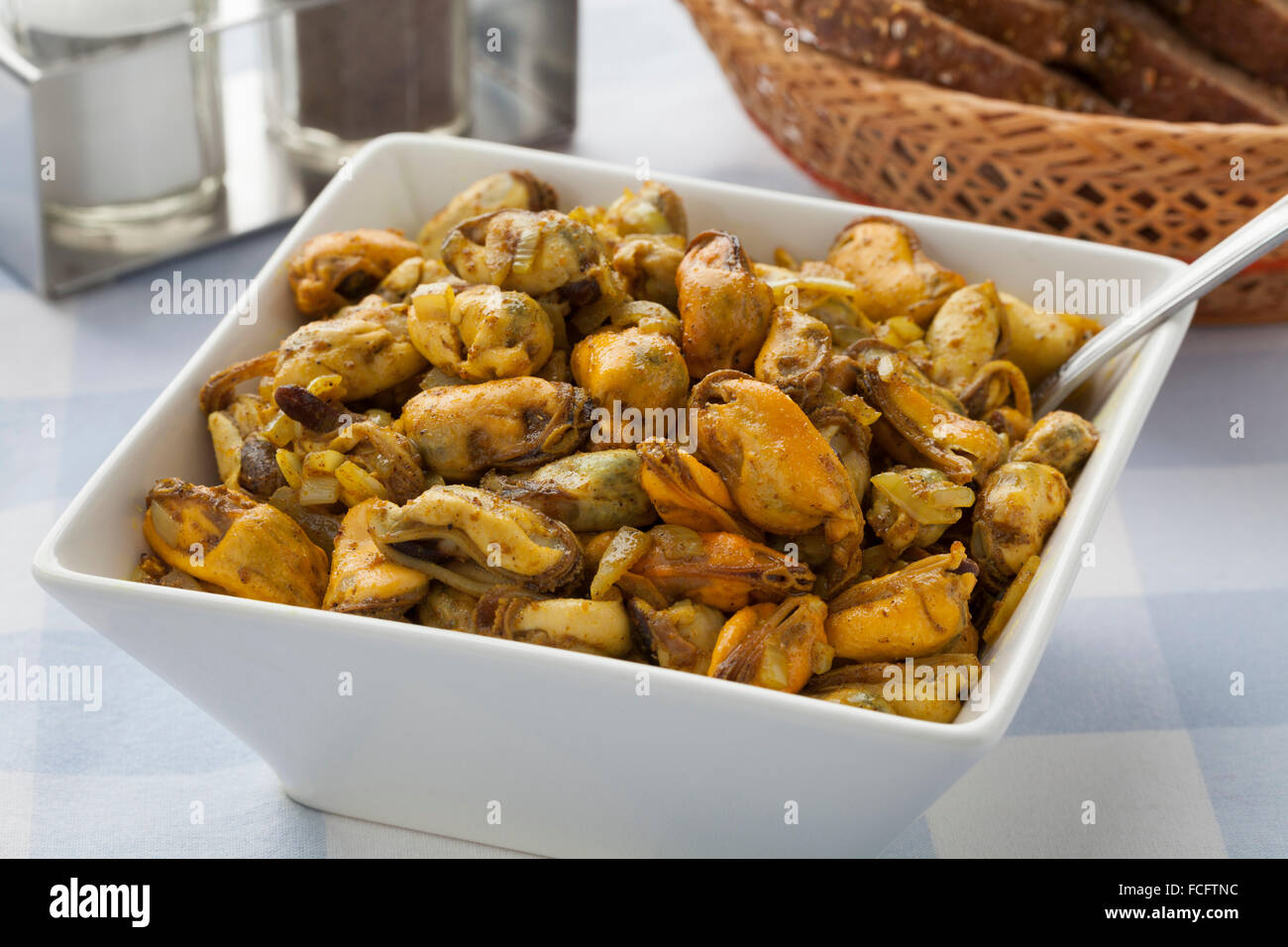 Dish with fresh baked mussels and curry Stock Photo