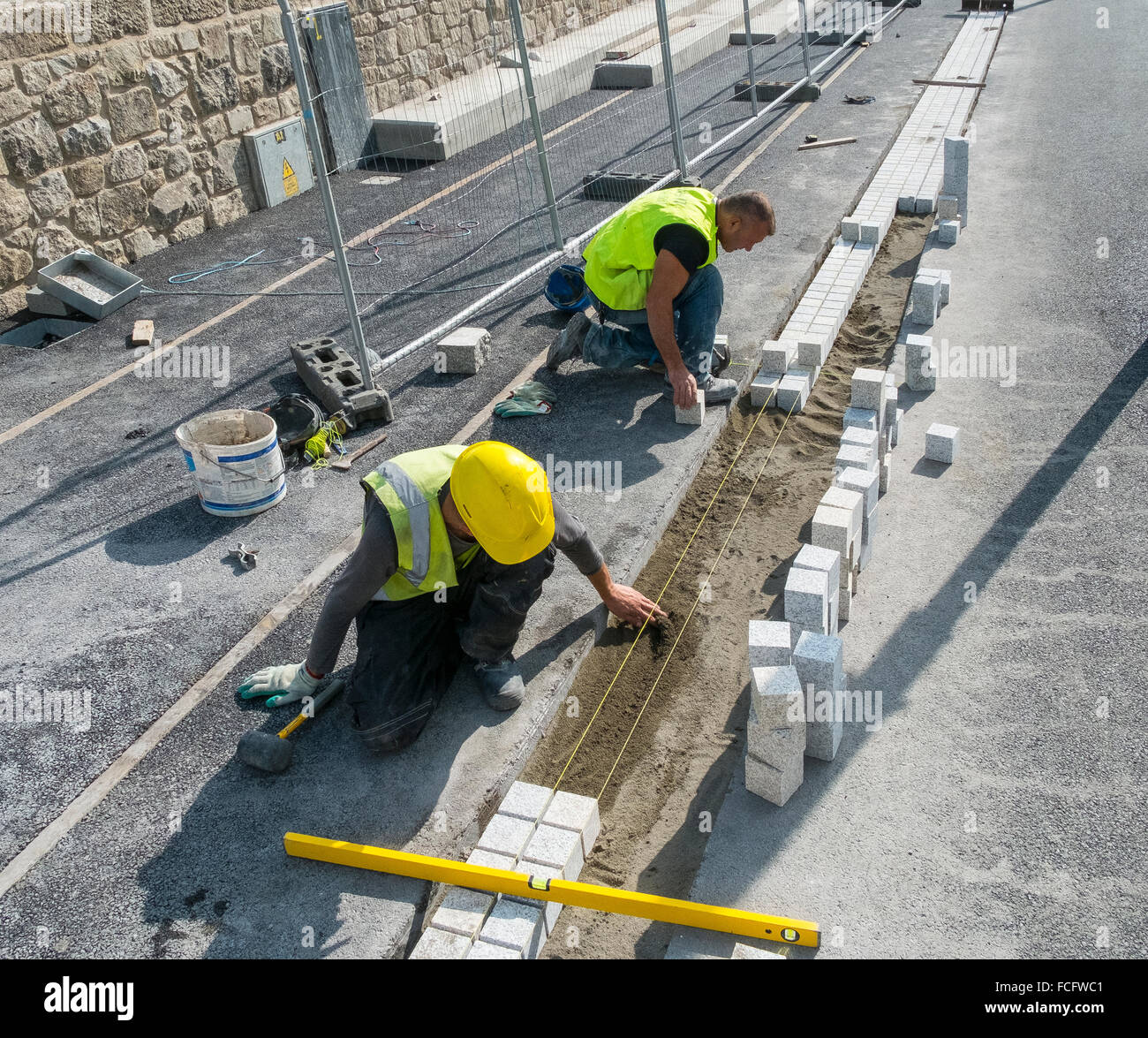 construction workers bricklayers paving paviors path Stock Photo