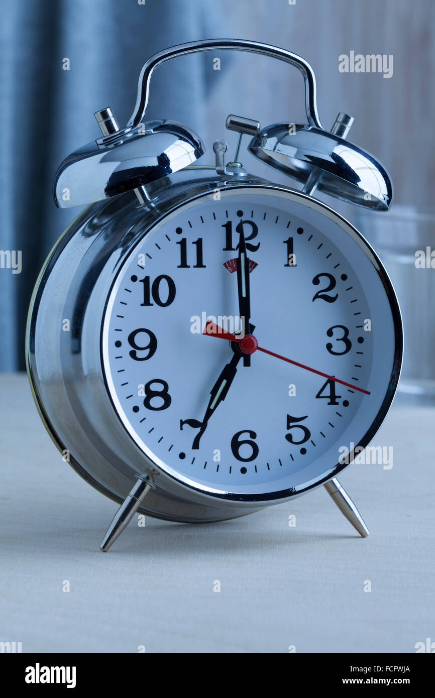 Traditional alarm clock at seven o'clock in the morning Stock Photo