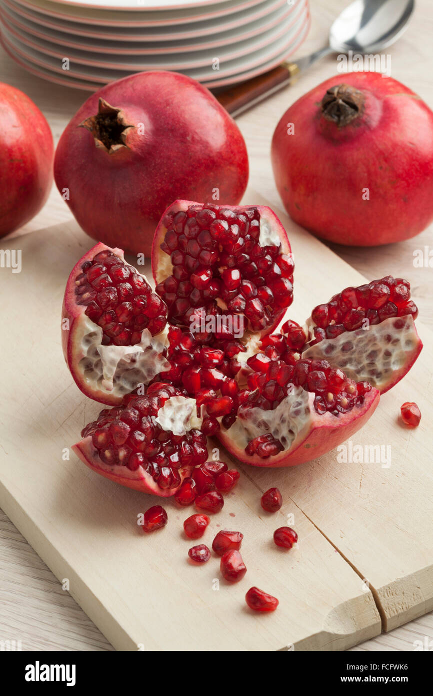 Open fresh red ripe pomegranate fruit and seeds Stock Photo