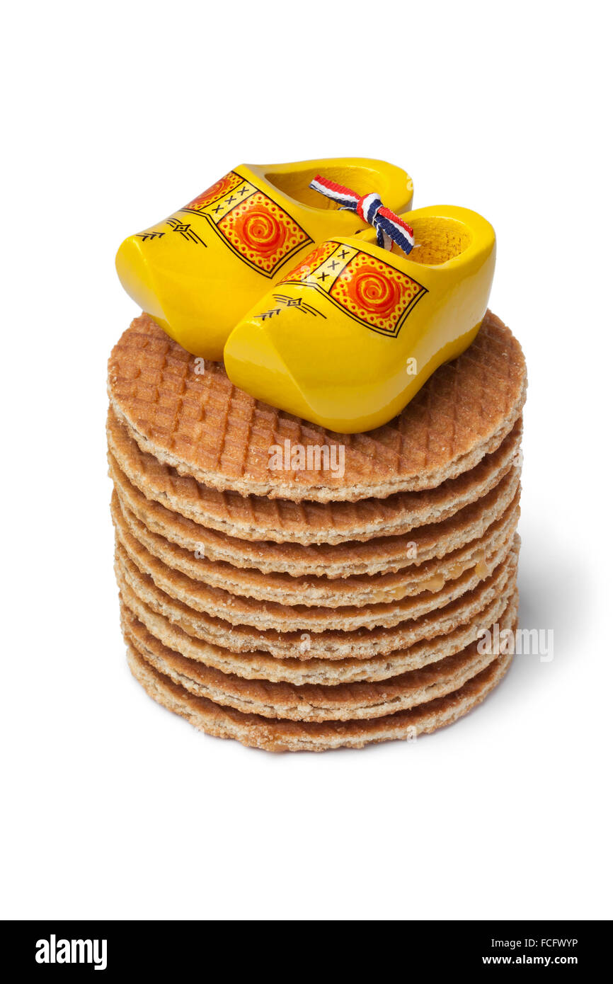 Fresh baked Dutch syrup waffles with yellow mini wooden shoes on white background Stock Photo