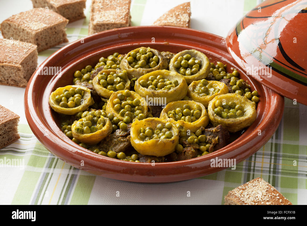 Traditional Moroccan tagine with meat, artichoke hearts and green peas