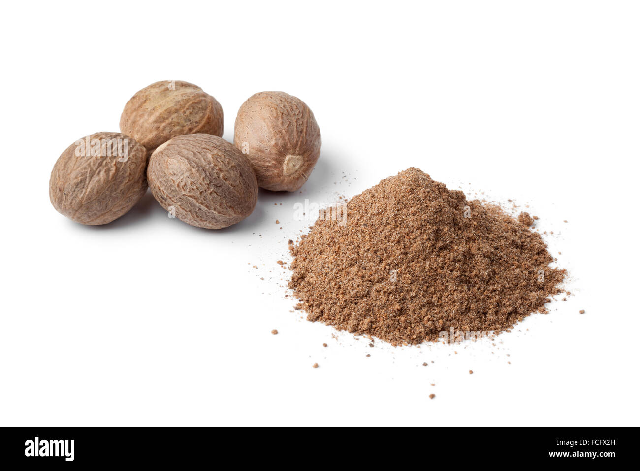 Heap of ground Nutmeg powder and seeds on white background Stock Photo Alamy