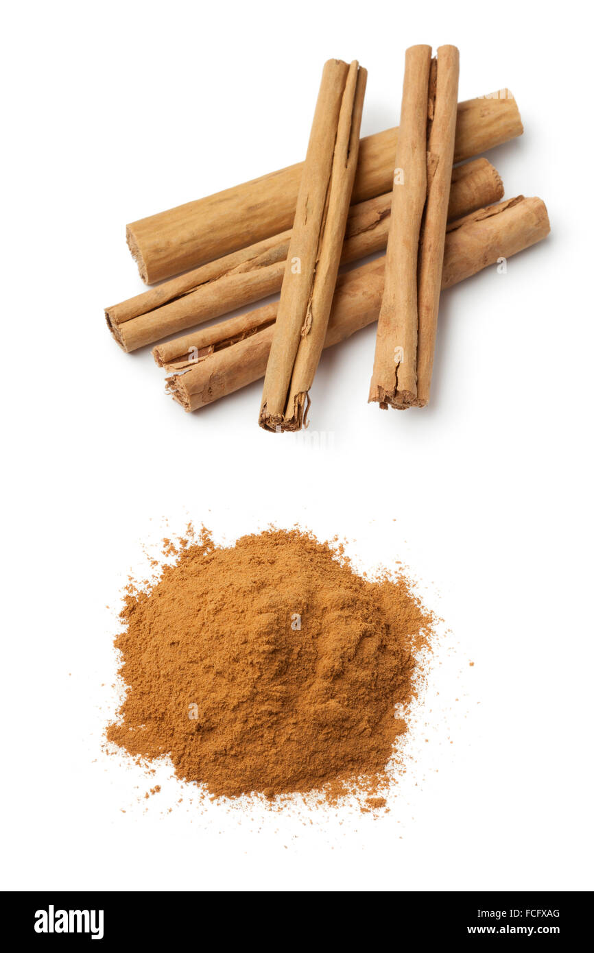 Cinnamon sticks and a heap of ground powder on white background Stock Photo