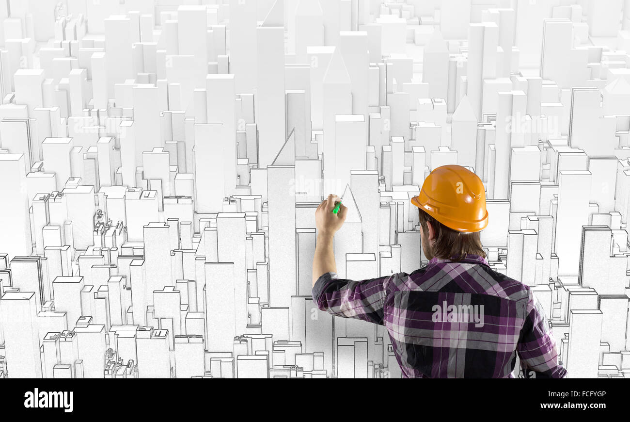 Rear view of engineer drawing project of business district Stock Photo ...