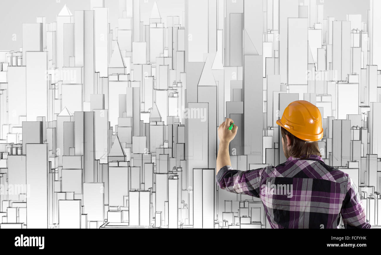 Rear view of engineer drawing project of business district Stock Photo ...