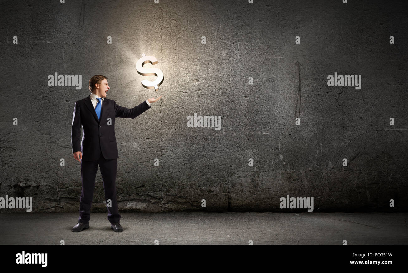 Businessman in suit holding dollar sign in palm Stock Photo - Alamy