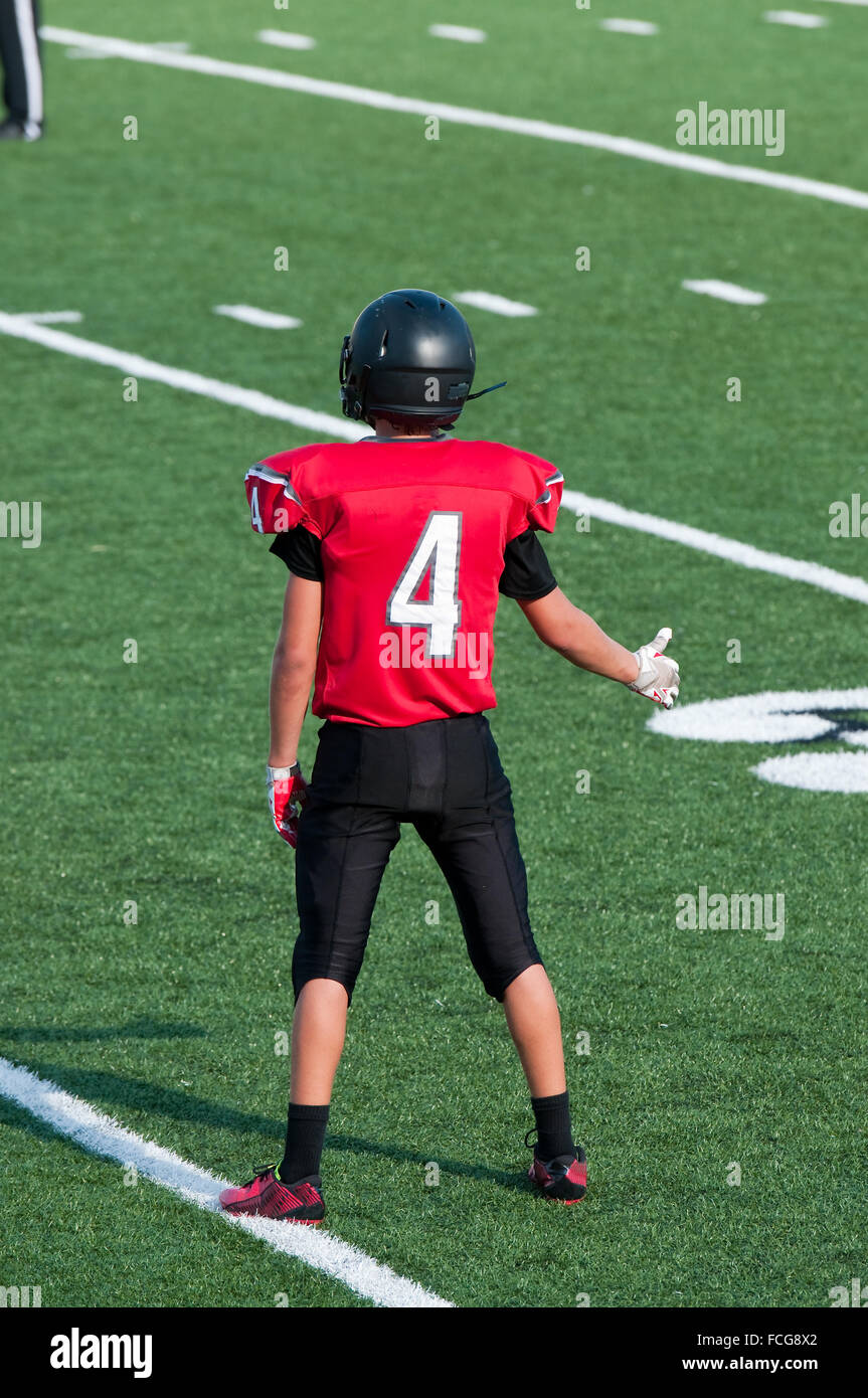 Teenage american football player giving a thumbs up on the field during a game. Stock Photo