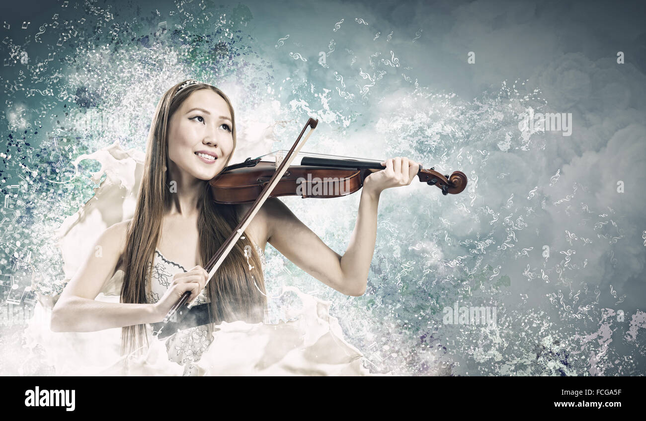 Young pretty asian woman playing violin. Young talent Stock Photo - Alamy