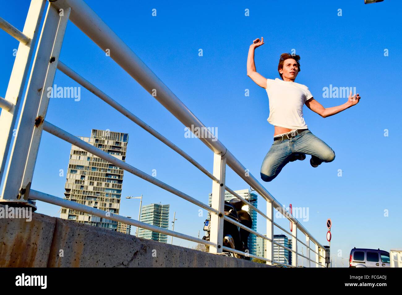 Young man jumping over railing hires stock photography and images Alamy