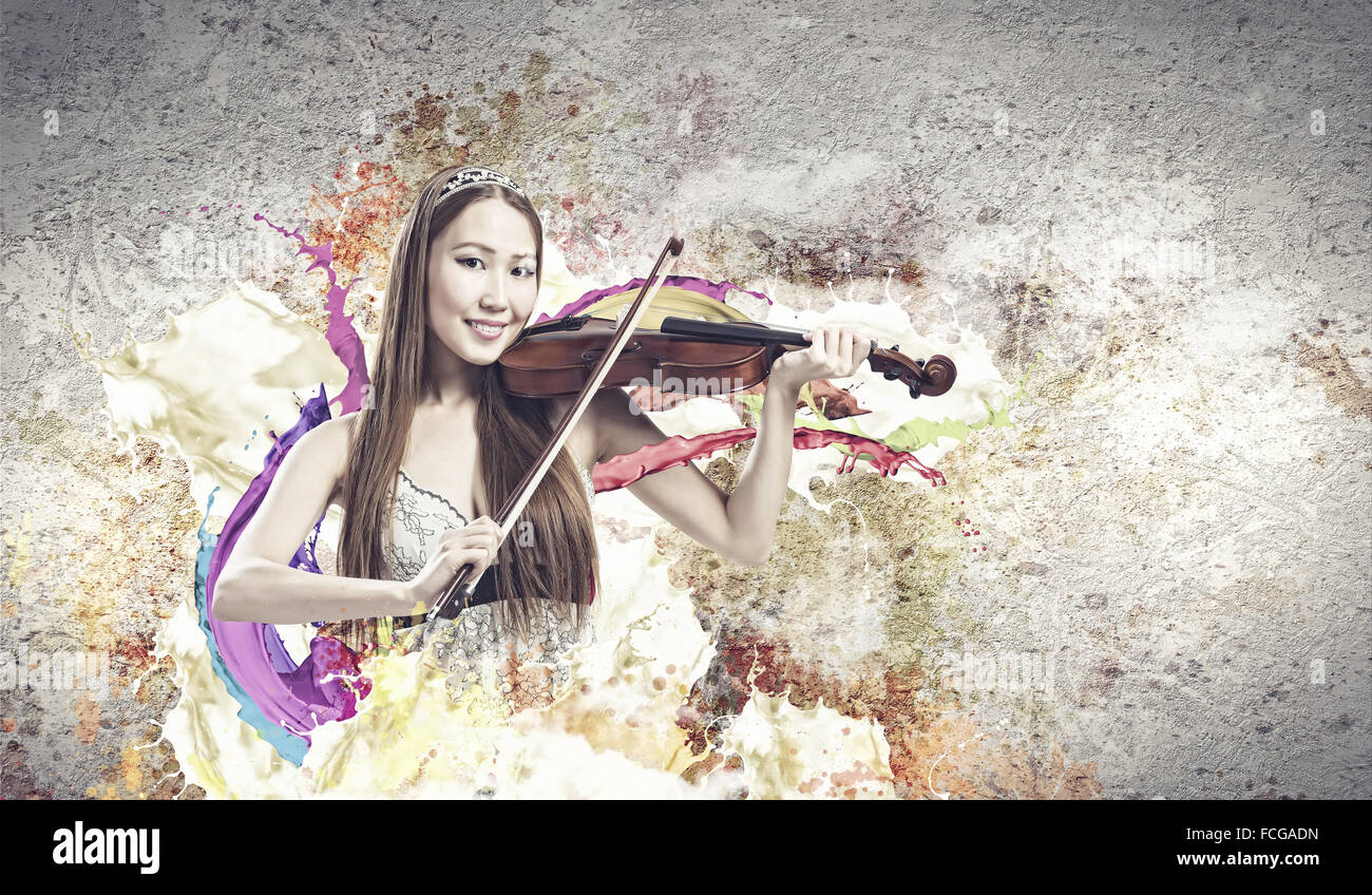 Young pretty asian woman playing violin. Young talent Stock Photo