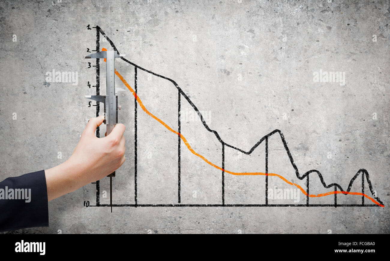 Graph About Measuring Close up of female hand measuring graph with ruler Stock Photo - Alamy