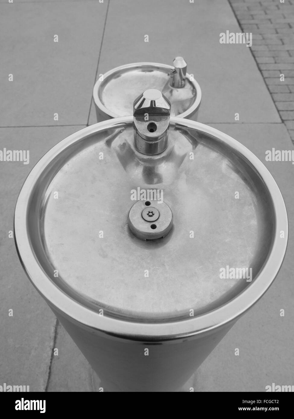 A short and a tall dry water fountain outdoors on the sidewalk in black and white at the Harbour Front in Toronto, Ontario, Cana Stock Photo