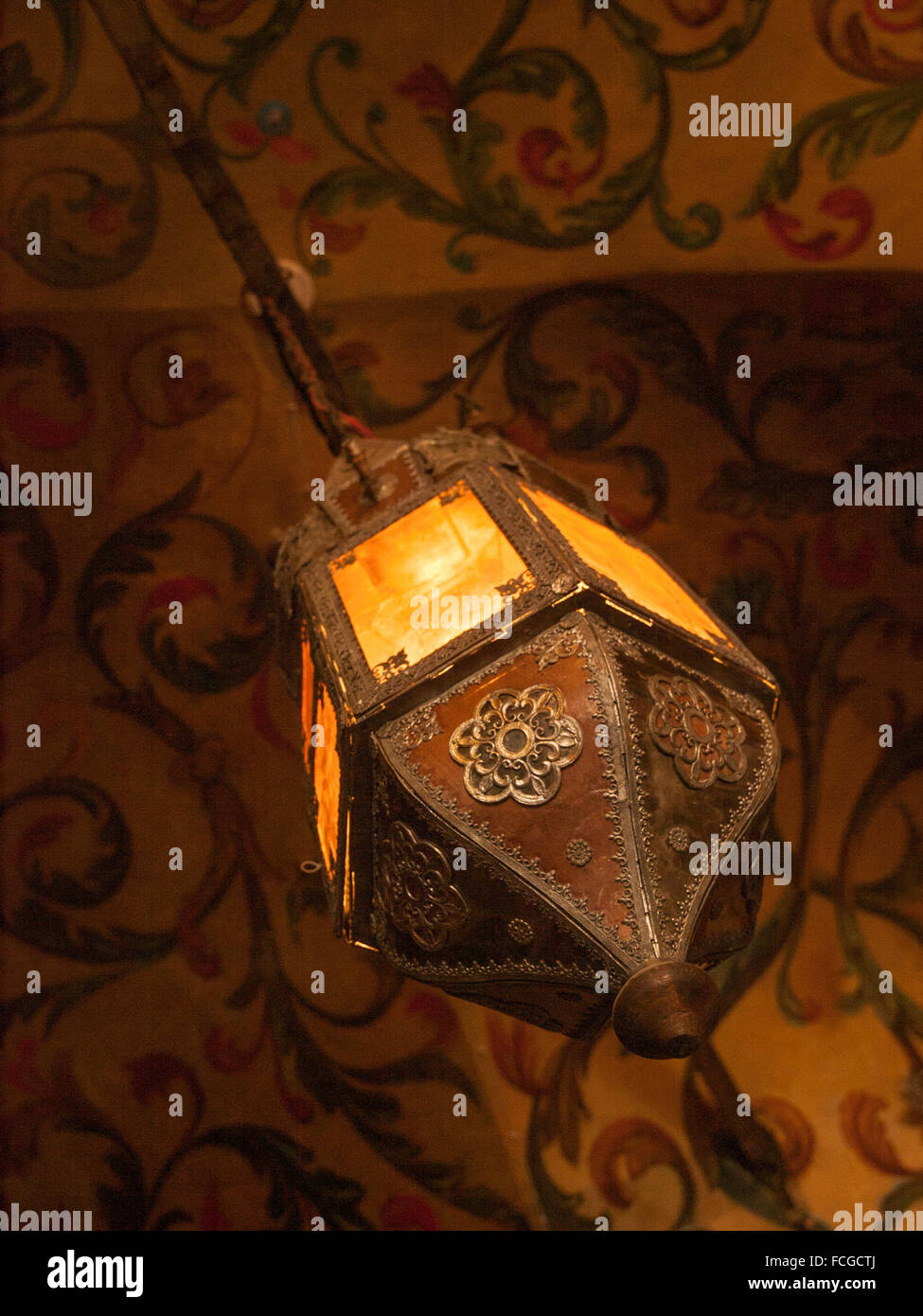 Hanging ornate light fixture and painted walls inside St Basils Cathedral in Moscow Russia. Stock Photo