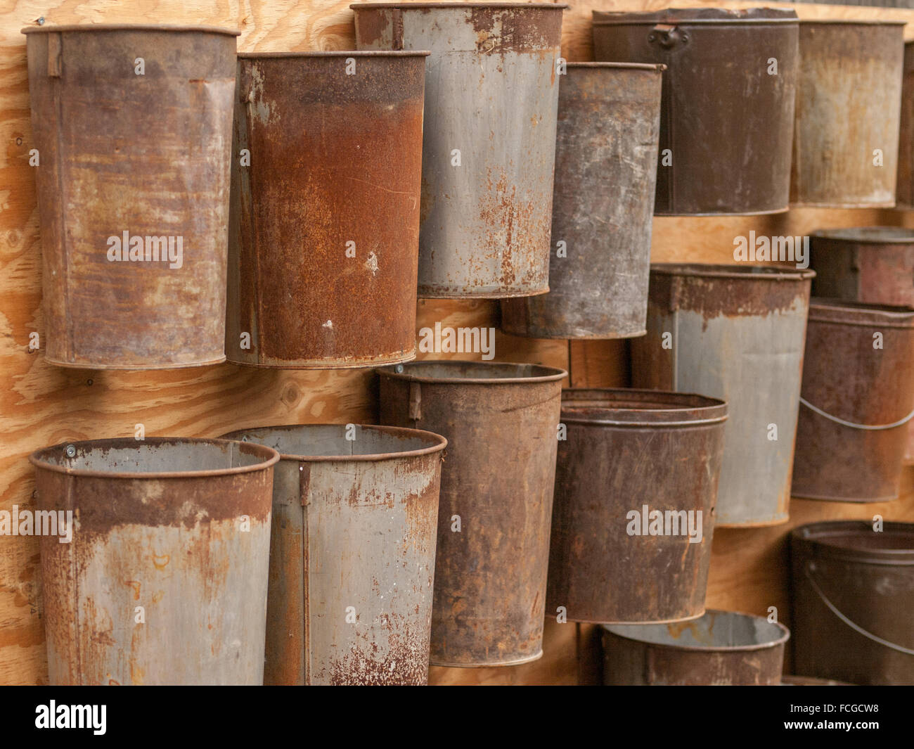 Collection of rusted vintage maple tree sap collecting buckets pinned