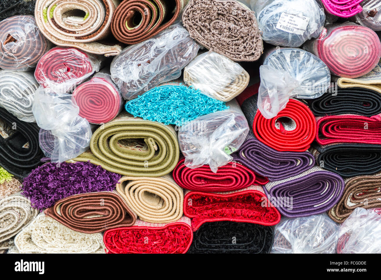 A pile of rolled up rugs ready for sale at Bantry Friday Market, West Cork, Ireland. Stock Photo