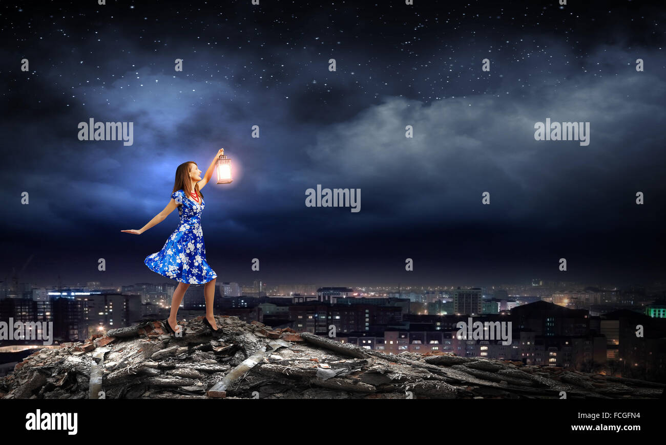Young woman in blue dress with lantern Stock Photo - Alamy