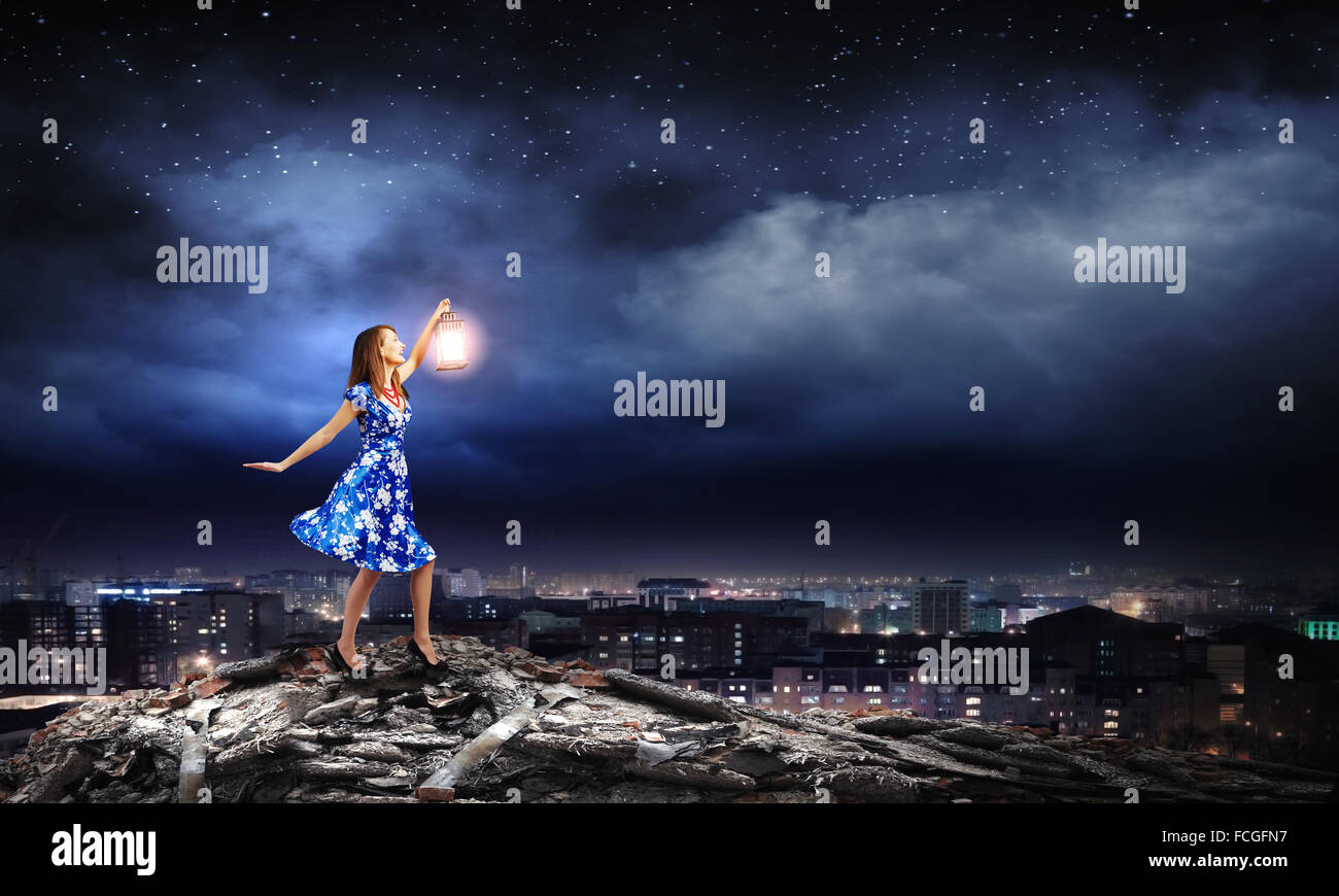 Young woman in blue dress with lantern Stock Photo - Alamy
