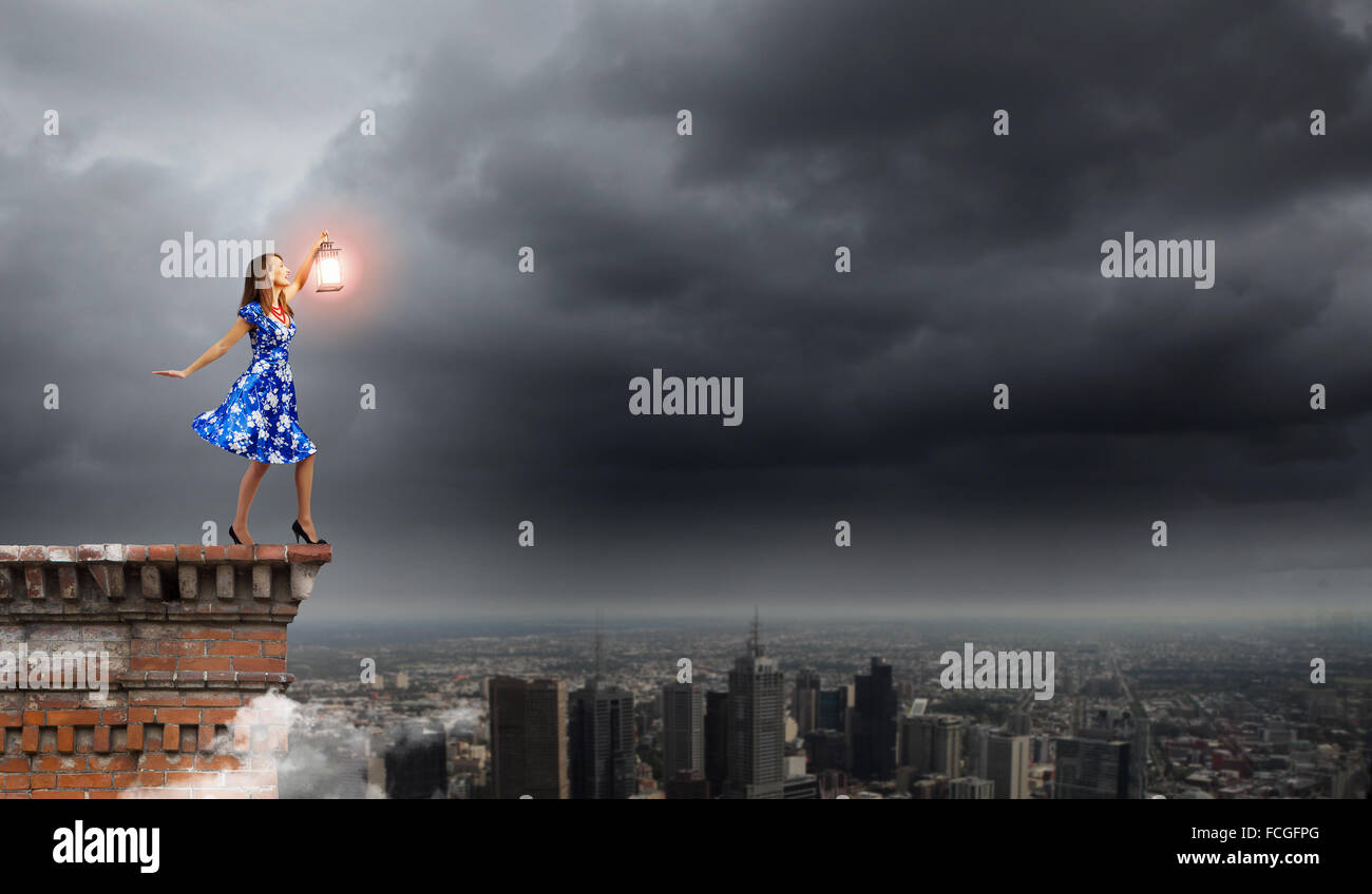 Young woman in blue dress with lantern Stock Photo - Alamy