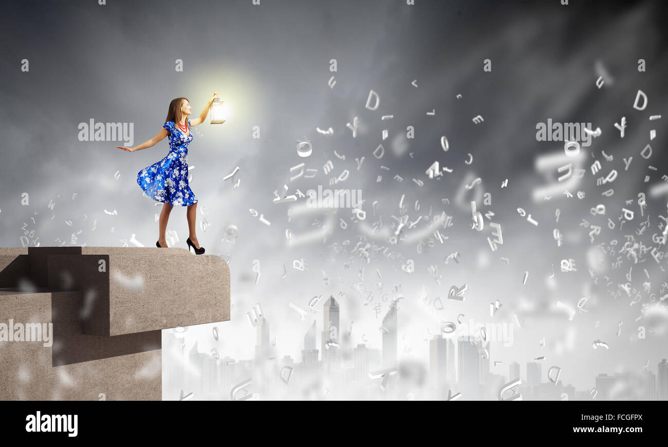 Young woman in blue dress with lantern Stock Photo - Alamy