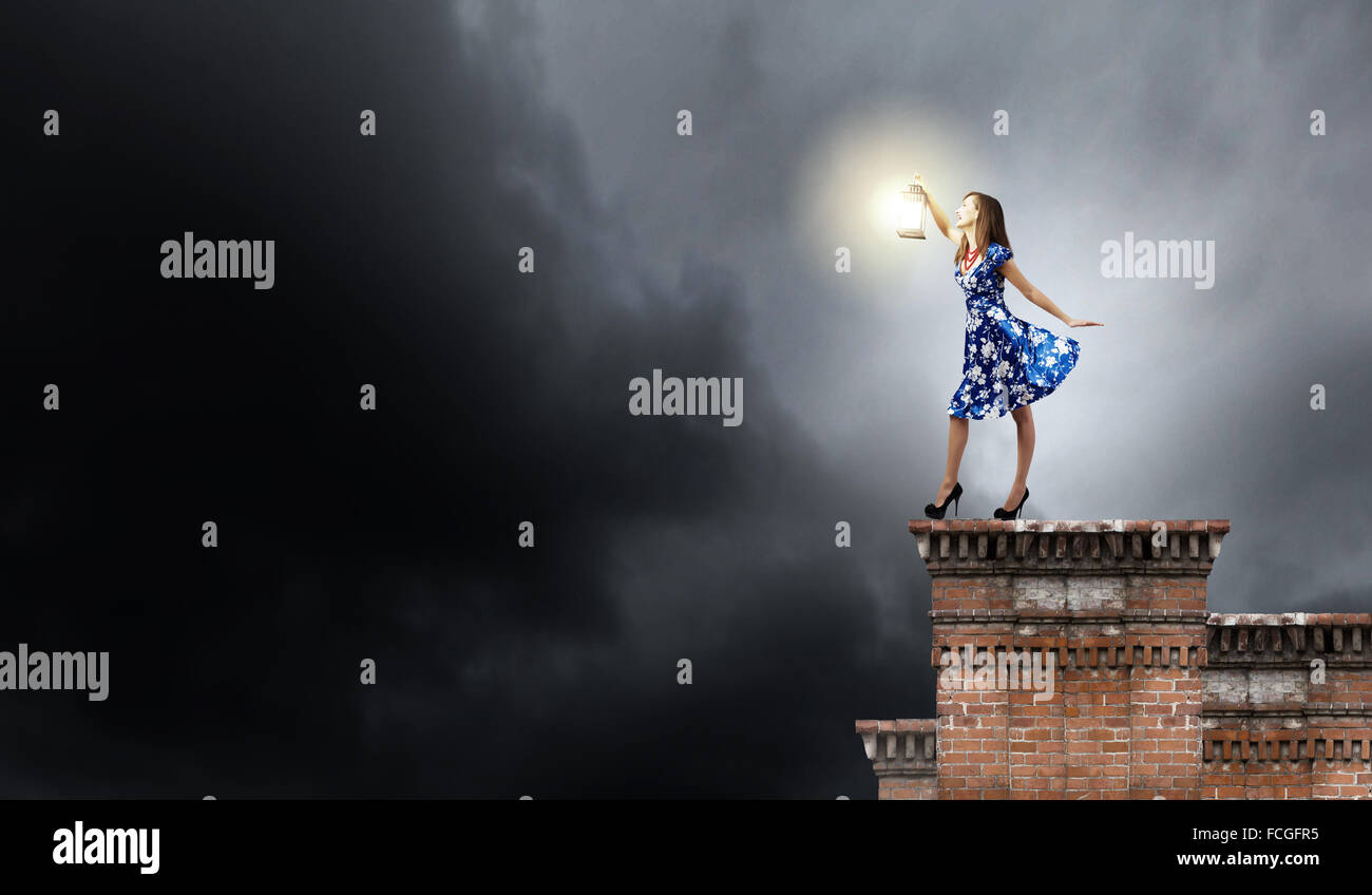 Young woman in blue dress with lantern Stock Photo - Alamy