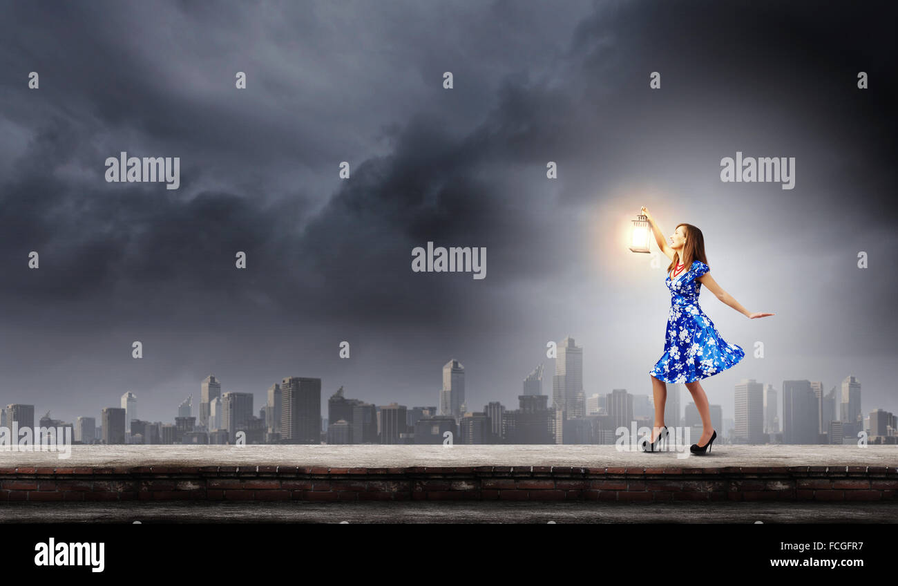 Young woman in blue dress with lantern Stock Photo - Alamy