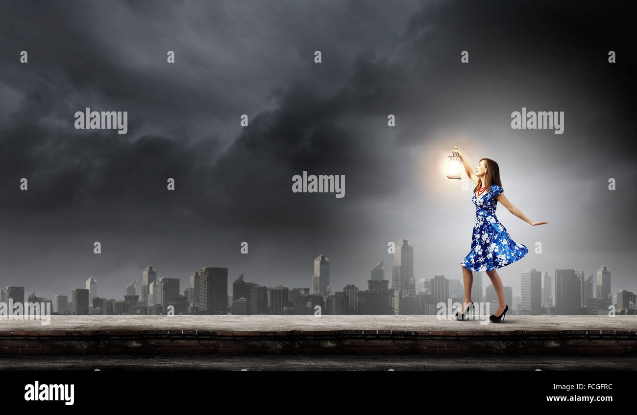 Young woman in blue dress with lantern Stock Photo - Alamy
