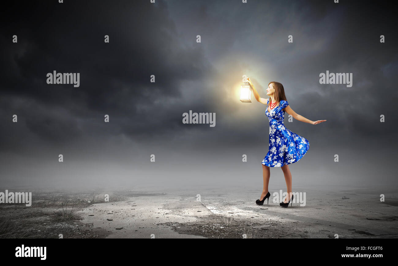 Young woman in blue dress with lantern Stock Photo - Alamy