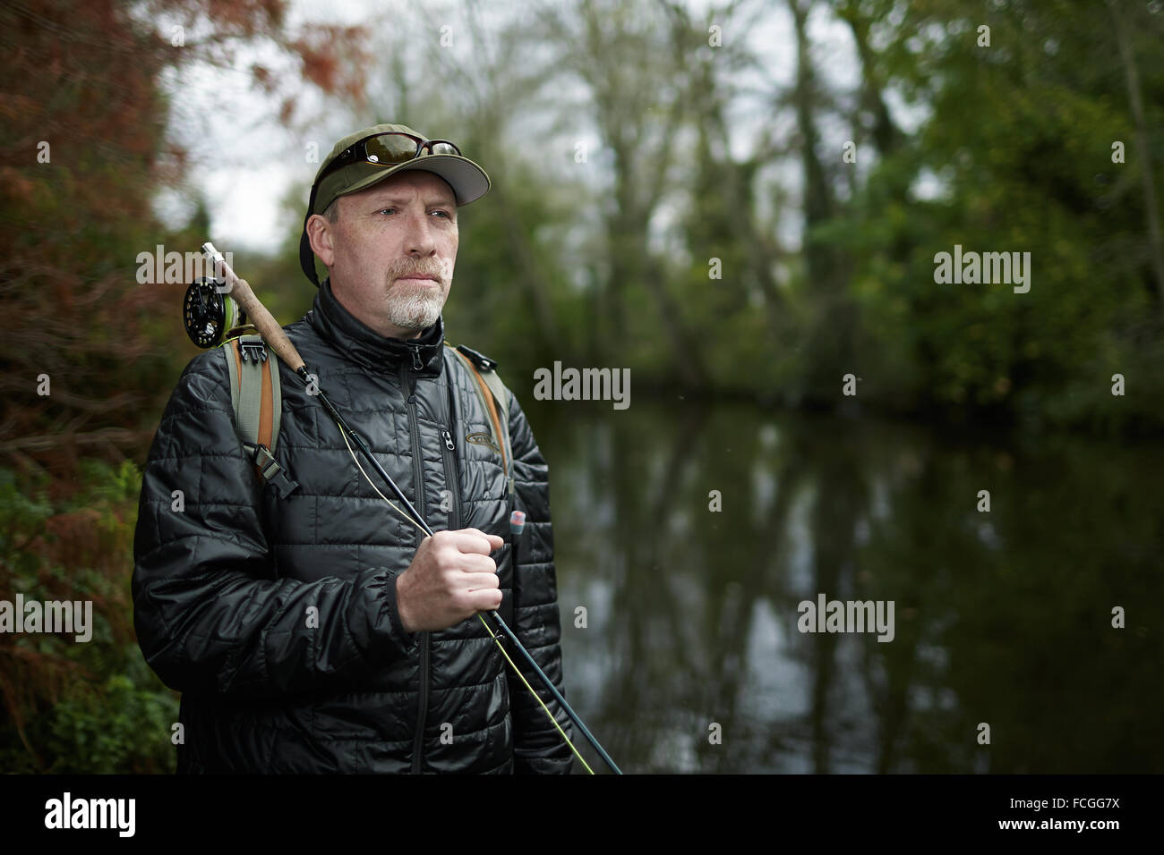 A man fly fishing in a river Stock Photo